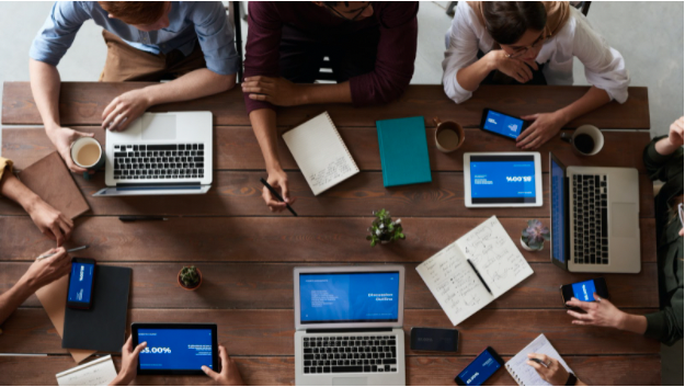 Students sitting around a table brainstorming ideas