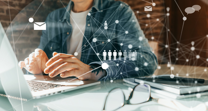 Person sitting at desk working on laptop computer and operating cisco core technologies